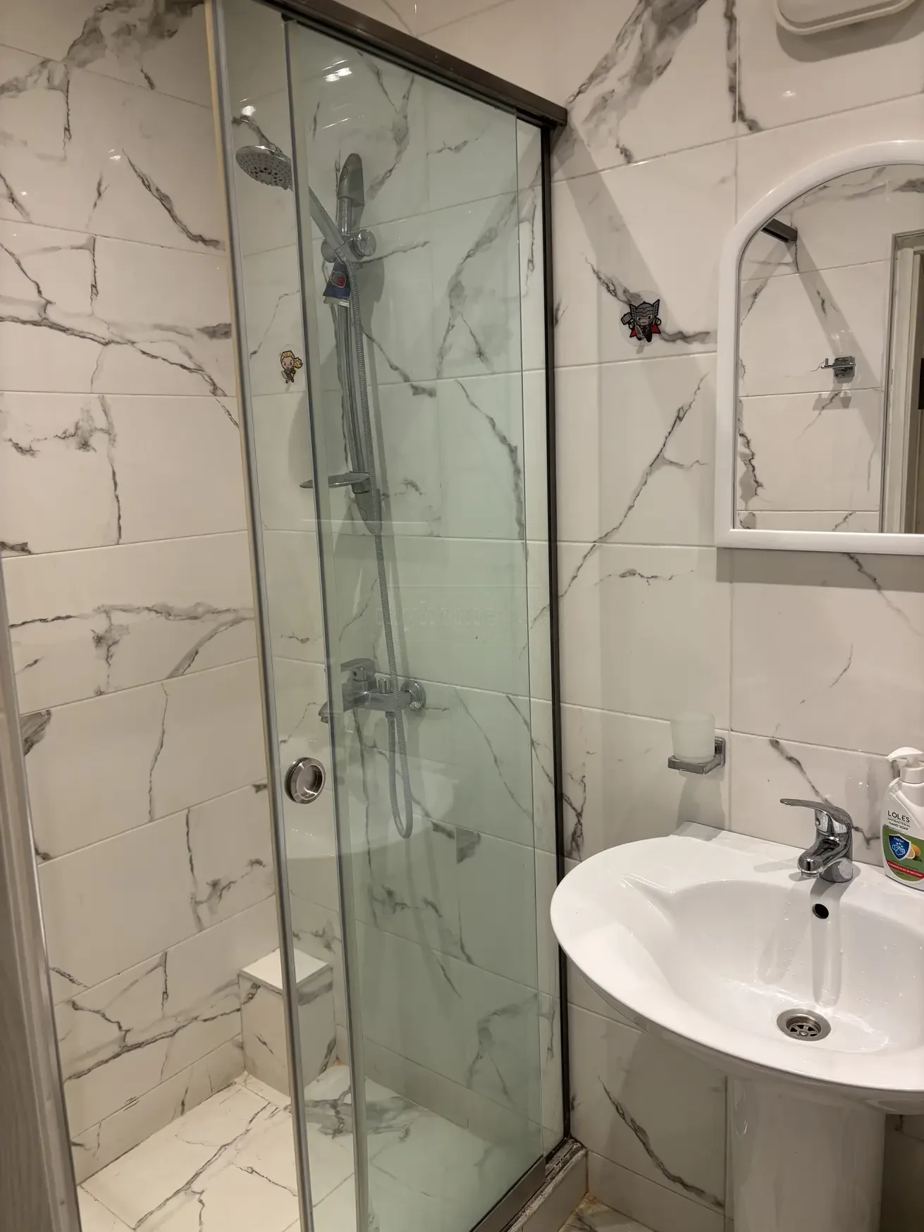 1-room apartment for rent on Aghmashenebeli Avenue, Chugureti, Tbilisi — marble-tiled bathroom with glass shower cabin