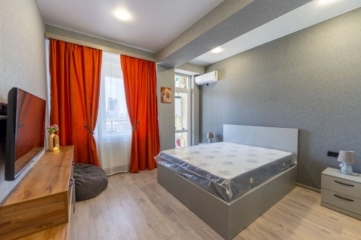 2-room apartment for rent on Chavchavadze Avenue 49b, Vake, Tbilisi — bedroom with double bed, TV and city view