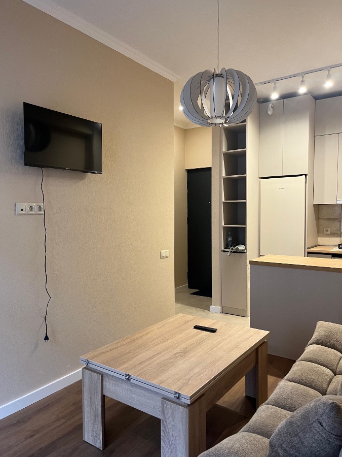 2-room apartment for rent on Chkondideli Street, Nadzaladevi, Tbilisi — living room with TV and coffee table