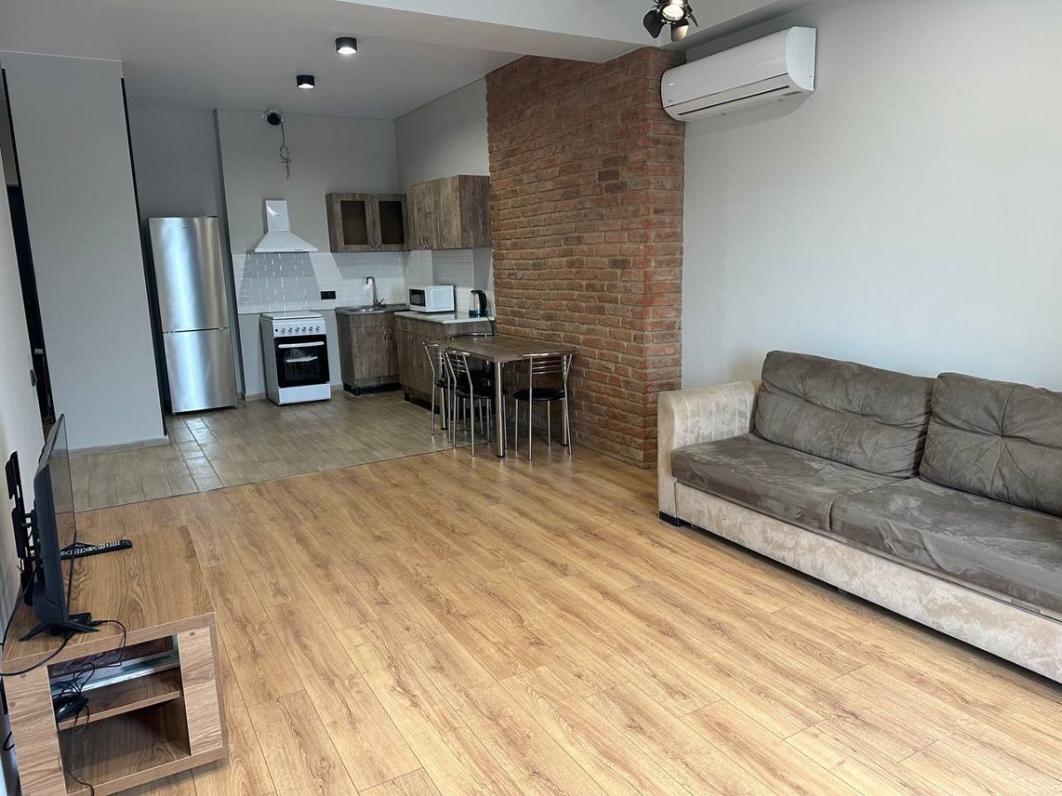 2-room apartment for rent on Chkondideli Street, Nadzaladevi, Tbilisi — open-plan kitchen and living room with appliances