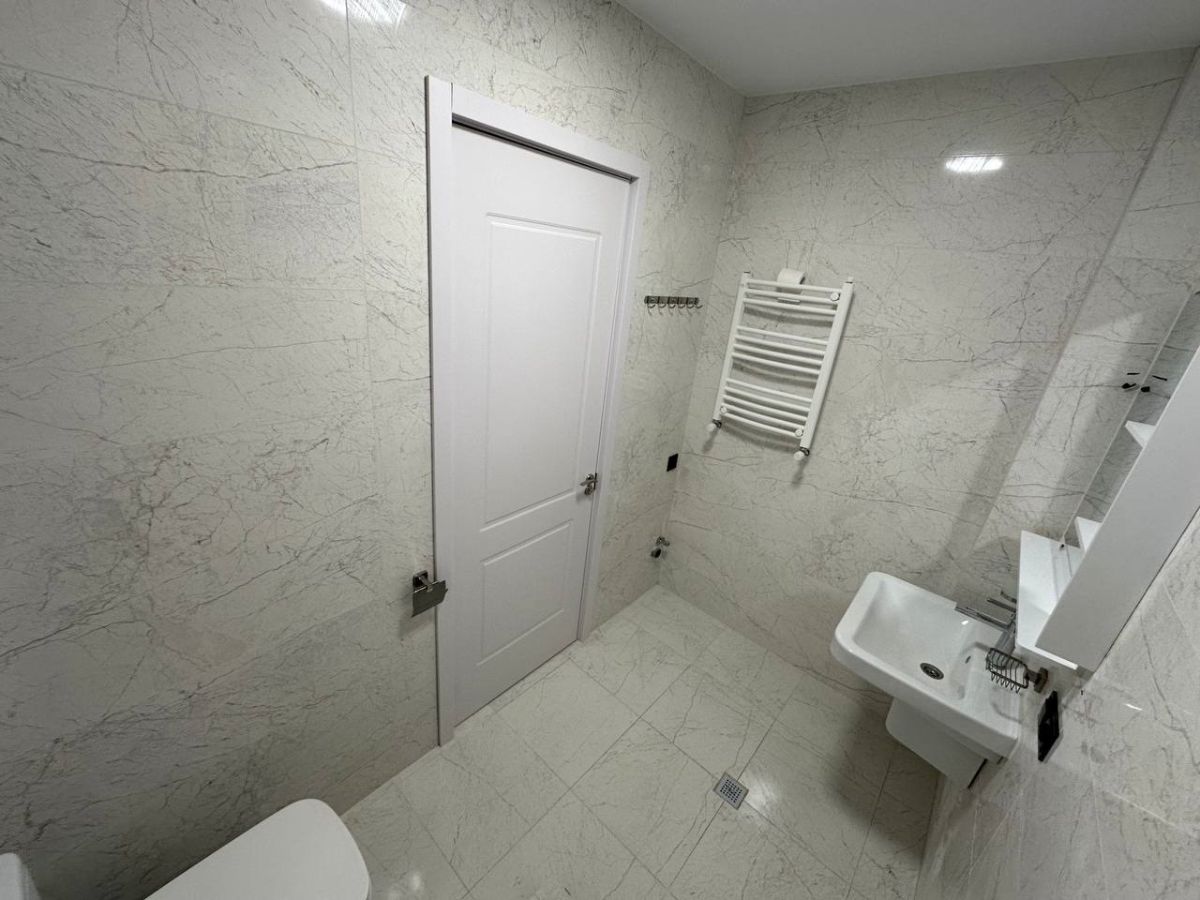 2-room apartment for rent on Chkondideli Street, Nadzaladevi, Tbilisi — marble bathroom with heated towel rail