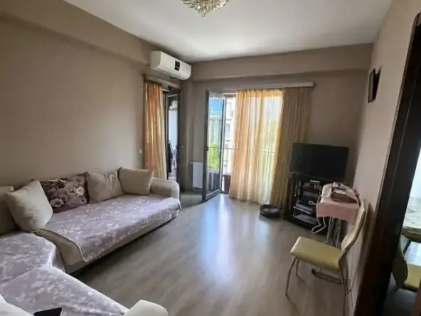 2-room apartment for rent on Nutsubidze Street, Saburtalo, Tbilisi — living room with sofa and balcony access