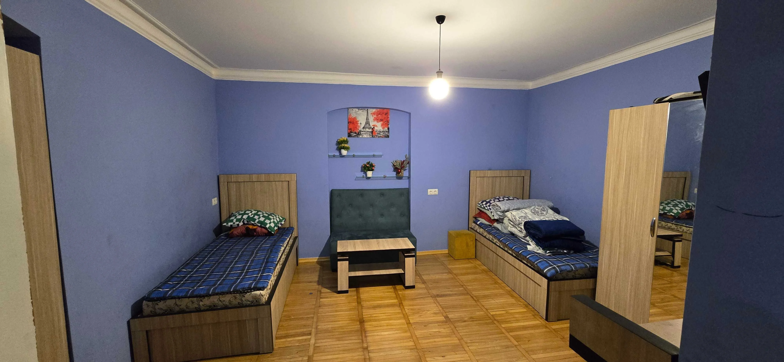 2-room apartment for rent on Rome Street, Chughureti, Tbilisi — main room with two single beds and seating area