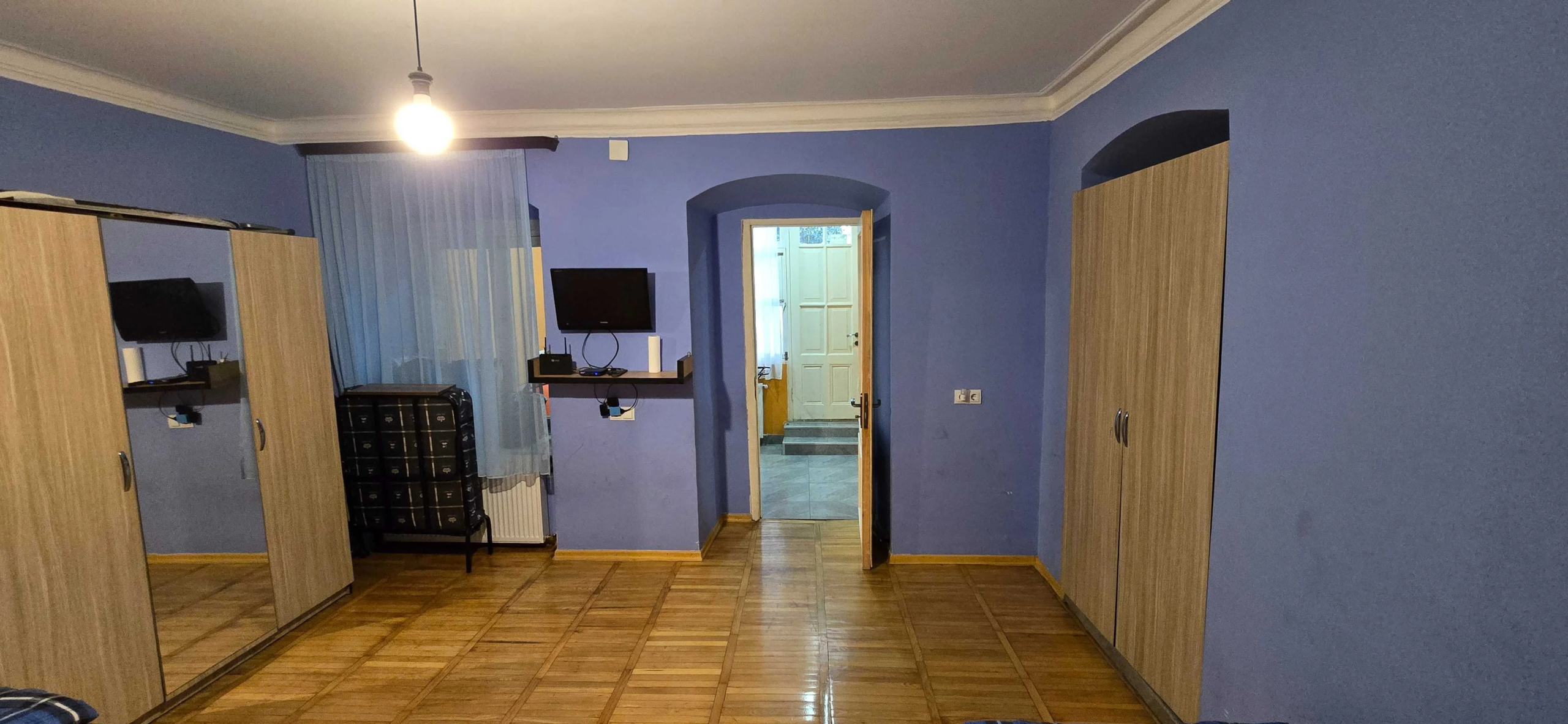 2-room apartment for rent on Rome Street, Chughureti, Tbilisi — main room with wardrobes and TV