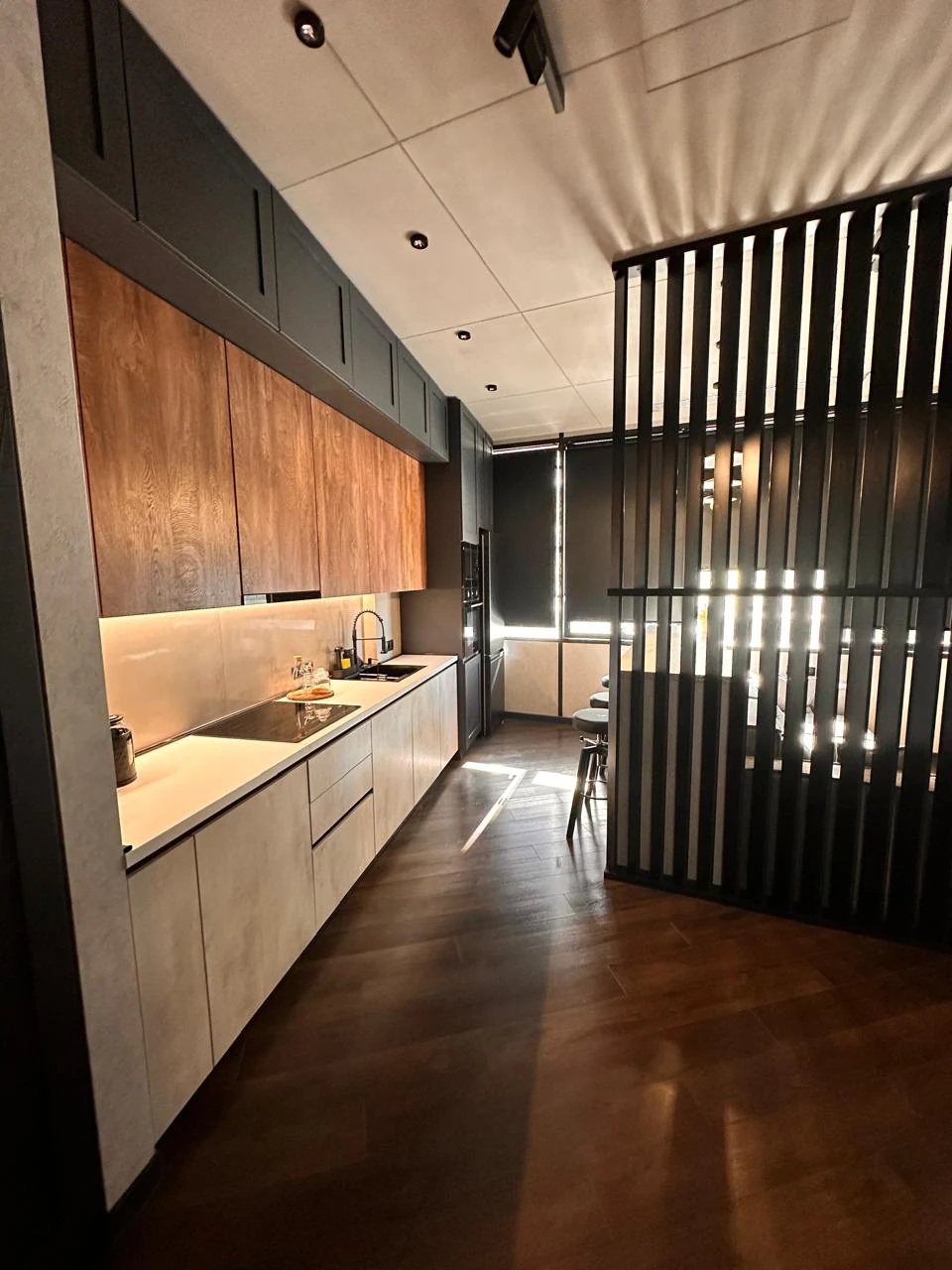 2-room apartment for sale on Chavchavadze Avenue, Vake, Tbilisi — galley kitchen with wood-panelled units and integrated appliances