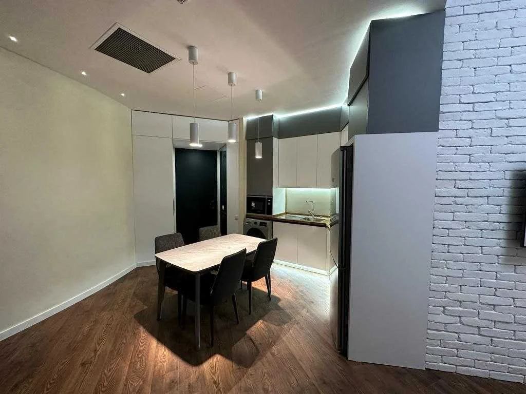 2-room apartment for sale on Ilia Chavchavadze Avenue, Vake, Tbilisi — dining table and fitted kitchen seen from the living room