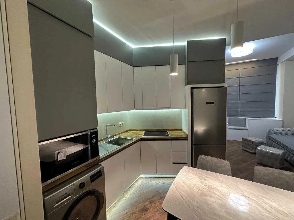 2-room apartment for sale on Ilia Chavchavadze Avenue, Vake, Tbilisi — fitted kitchen with induction hob, oven, microwave, fridge and washing machine