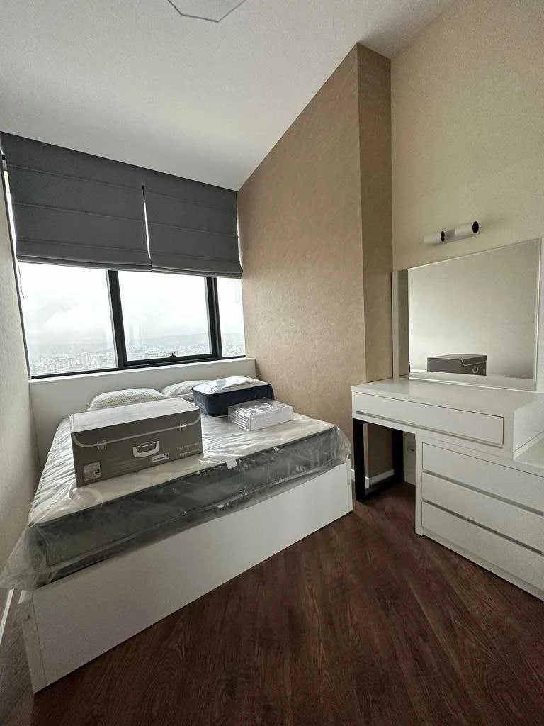 2-room apartment for sale on Ilia Chavchavadze Avenue, Vake, Tbilisi — bedroom with a city-facing window, built-in bed and dressing table