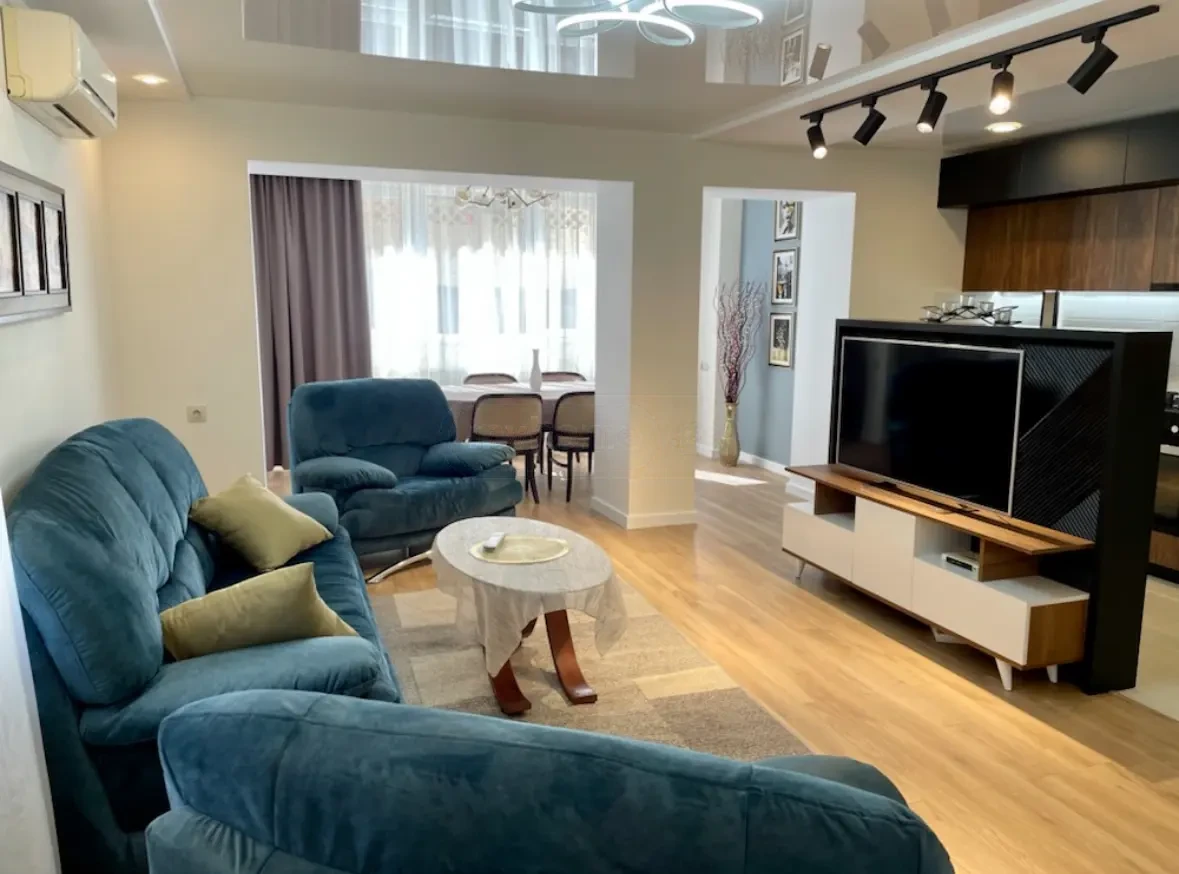 2-room apartment for sale on Irakli Abashidze Street, Vake, Tbilisi — living room with open dining area and built-in kitchen beyond