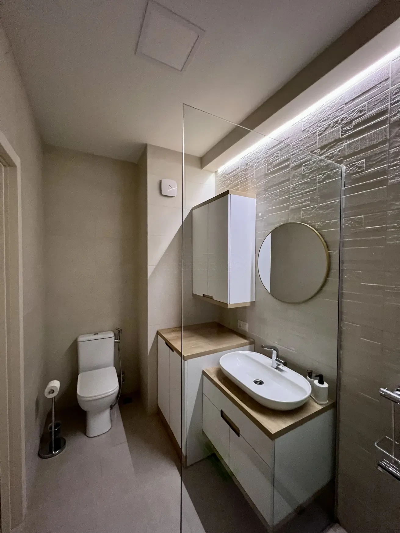 2-room furnished apartment for sale on Mindeli Street 9b, Saburtalo, Tbilisi — bathroom with LED-lit stone accent wall