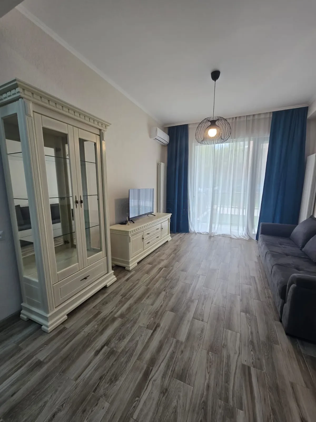 2-room furnished apartment for sale on Mindeli Street 9b, Saburtalo, Tbilisi — living room with display cabinet and TV