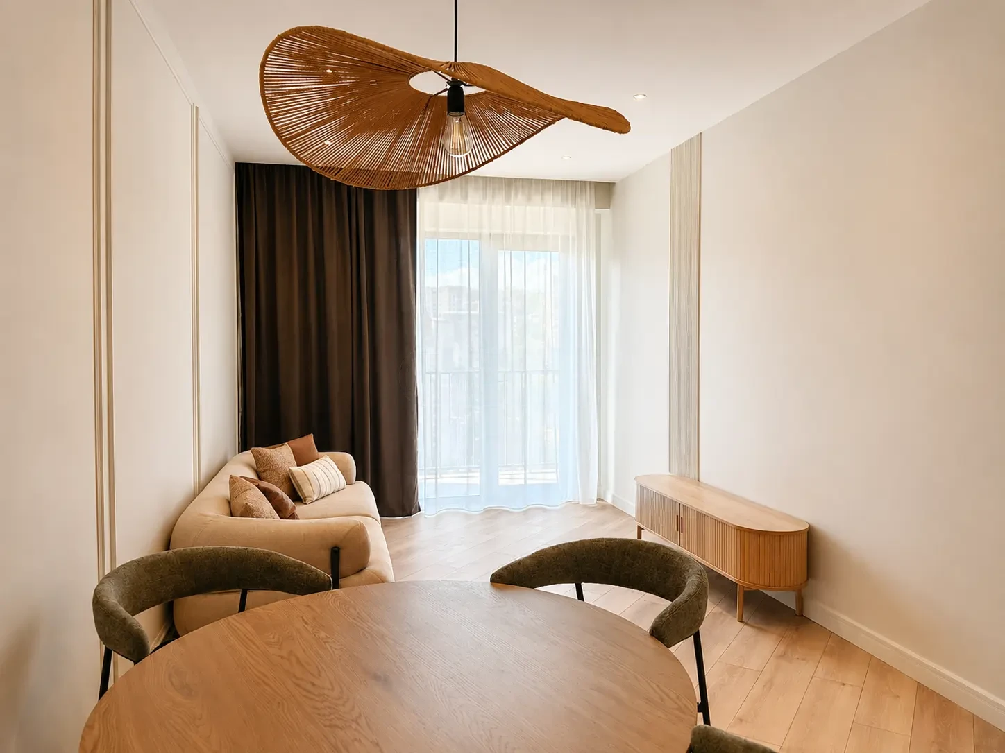 2-room furnished apartment for sale on Nutsubidze Street 125, top floor, Saburtalo, Tbilisi — living room with rattan pendant and balcony door