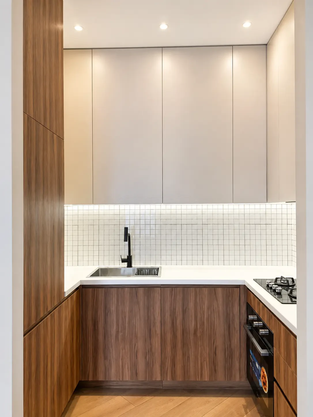 2-room furnished apartment for sale on Nutsubidze Street 125, top floor, Saburtalo, Tbilisi — kitchen with walnut cabinetry and black fixtures