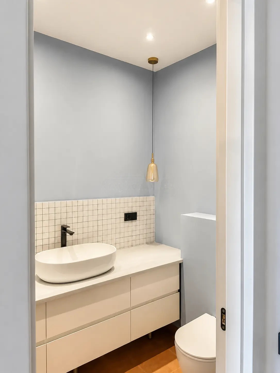 2-room furnished apartment for sale on Nutsubidze Street 125, top floor, Saburtalo, Tbilisi — bathroom with pale blue walls and brass pendant