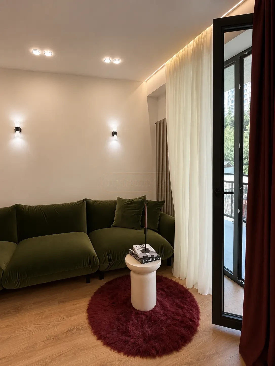 2-room apartment for sale on Nutsubidze Street 195, Saburtalo, Tbilisi — living room with green velvet sofa and balcony door