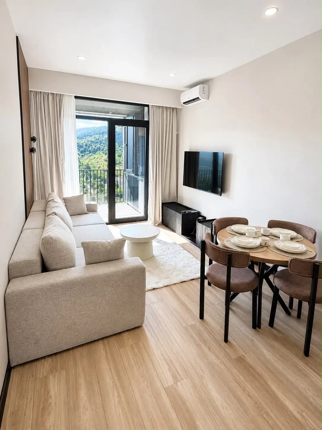 2-room furnished apartment for sale on Politkovskaya Street 46, 16th floor, Saburtalo, Tbilisi — living room with dining set and balcony view