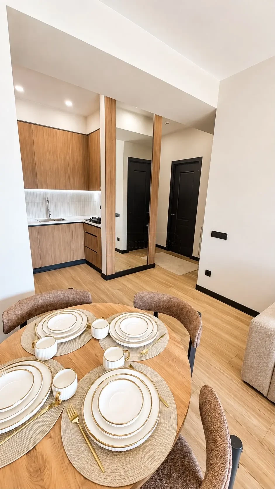2-room furnished apartment for sale on Politkovskaya Street 46, 16th floor, Saburtalo, Tbilisi — dining table set for four with kitchen behind