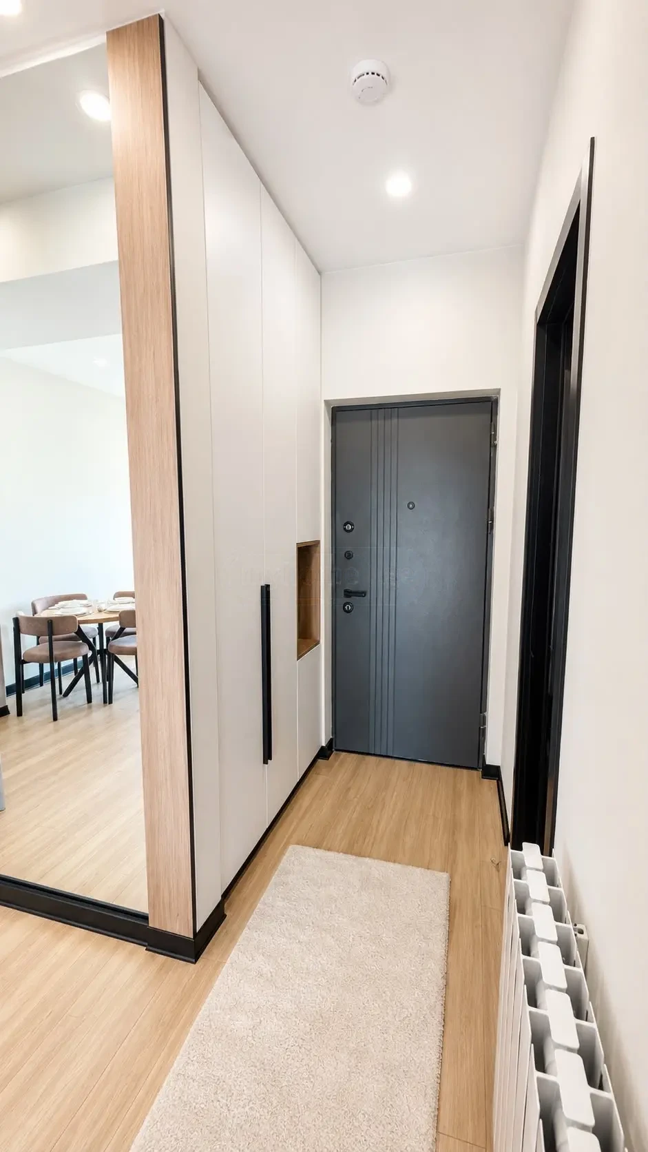 2-room furnished apartment for sale on Politkovskaya Street 46, 16th floor, Saburtalo, Tbilisi — entrance hallway with built-in wardrobe