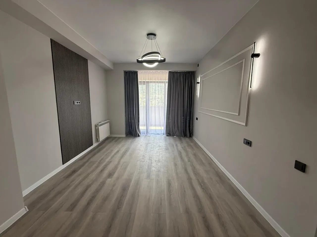 2-room apartment for sale on Politkovskaya Street, Saburtalo, Tbilisi — living room with balcony doors and curtains