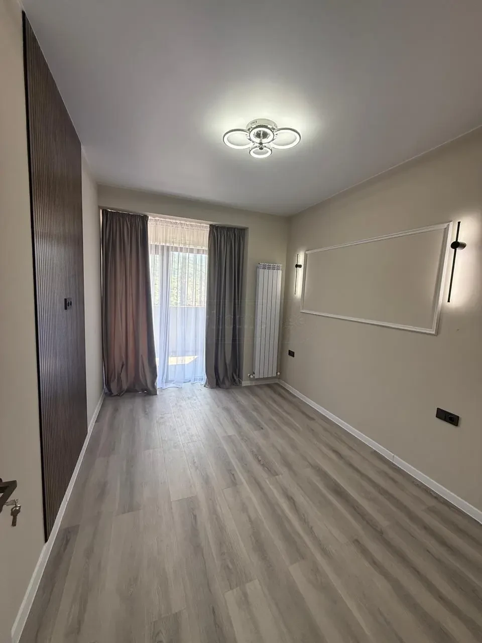 2-room apartment for sale on Politkovskaya Street, Saburtalo, Tbilisi — bedroom with built-in wardrobe and balcony exit