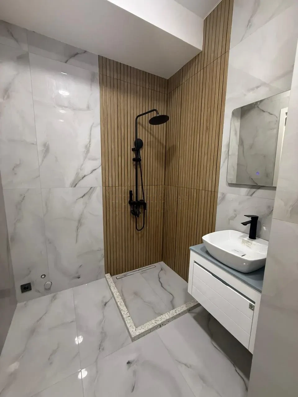 2-room apartment for sale on Politkovskaya Street, Saburtalo, Tbilisi — bathroom with walk-in rain shower and wood-look tile