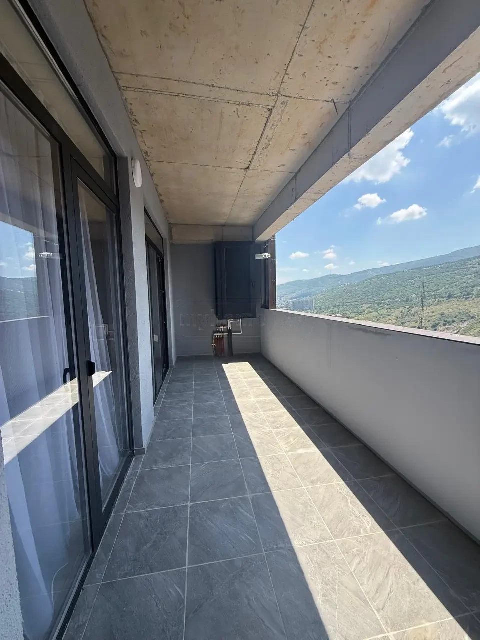 2-room apartment for sale on Politkovskaya Street, Saburtalo, Tbilisi — spacious tiled balcony with mountain views