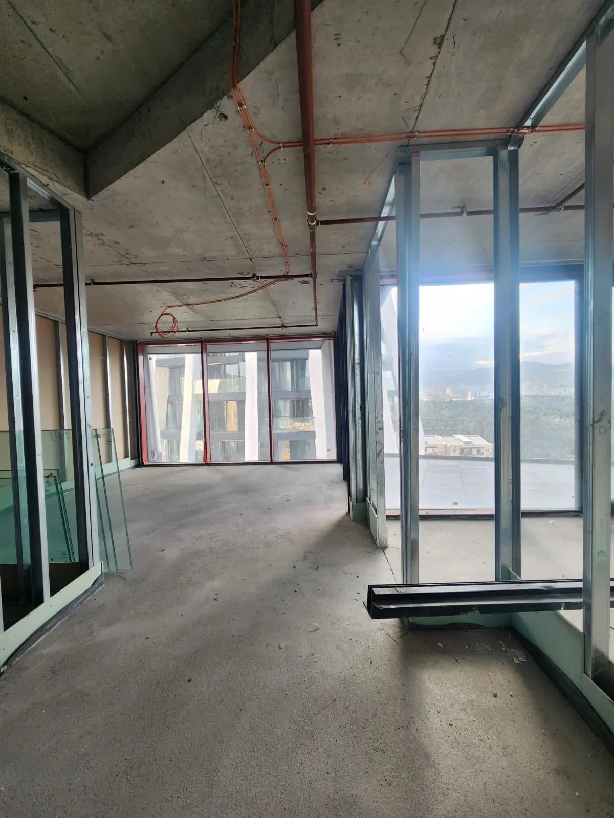 2-room apartment for sale on Tamarashvili Street, Vake, Tbilisi — main living space with floor-to-ceiling glazing and terrace access
