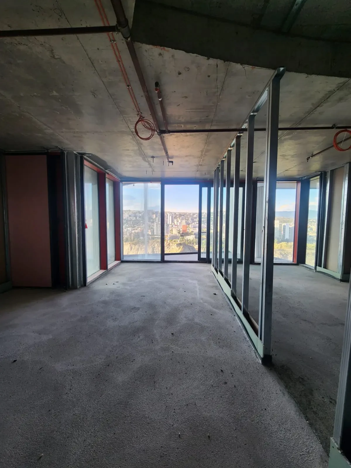 2-room apartment for sale on Tamarashvili Street, Vake, Tbilisi — open white-frame interior with panoramic windows