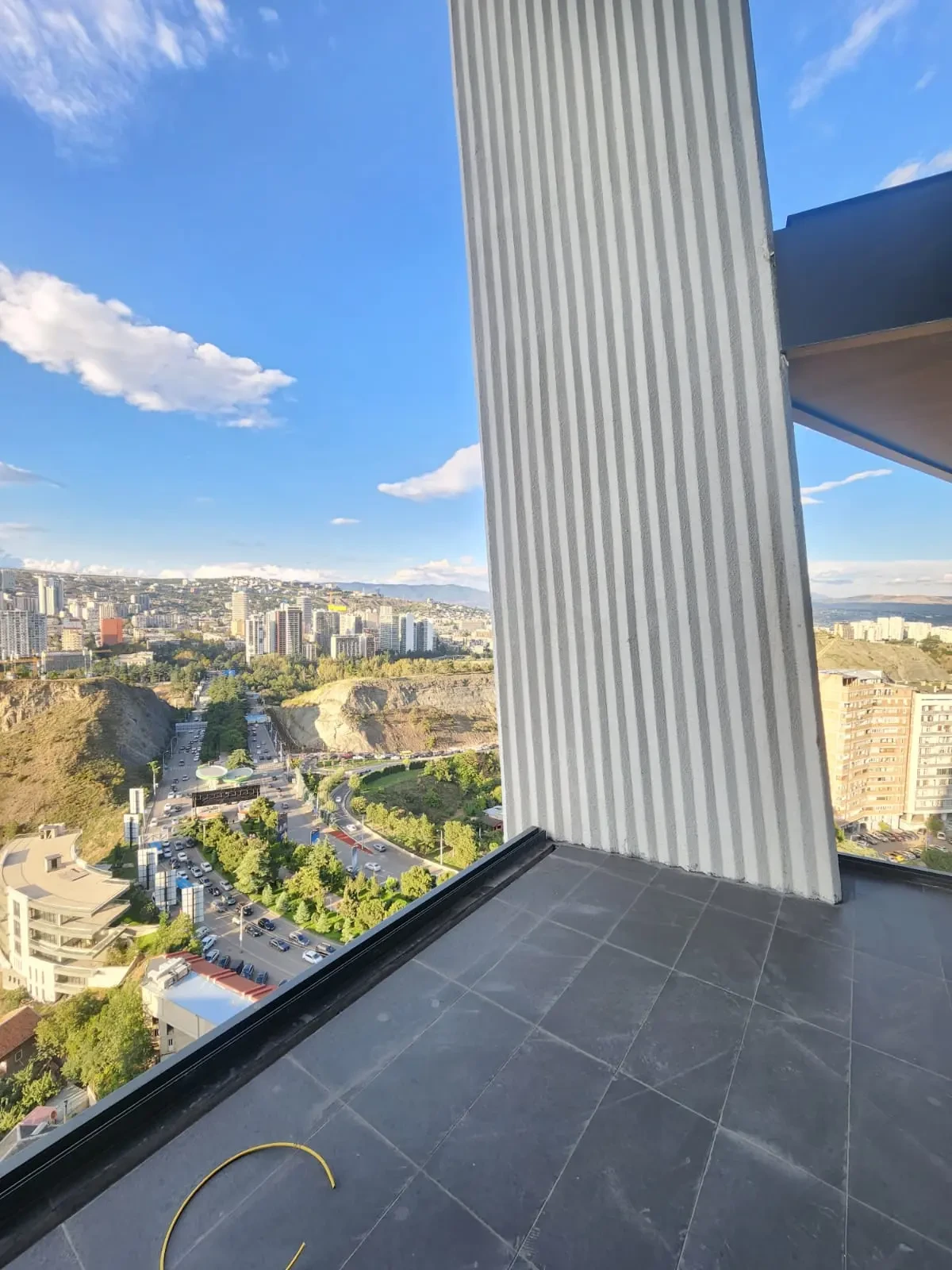 2-room apartment for sale on Tamarashvili Street, Vake, Tbilisi — tiled terrace with city and hillside view