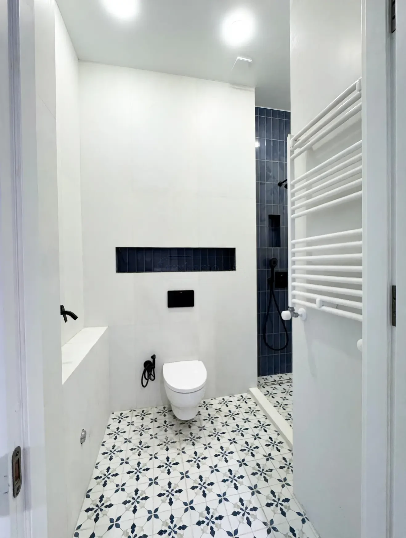 2-room apartment for sale on Tsinamdzghvrishvili Street, Chugureti, Tbilisi — designer bathroom in white and navy tile with walk-in shower