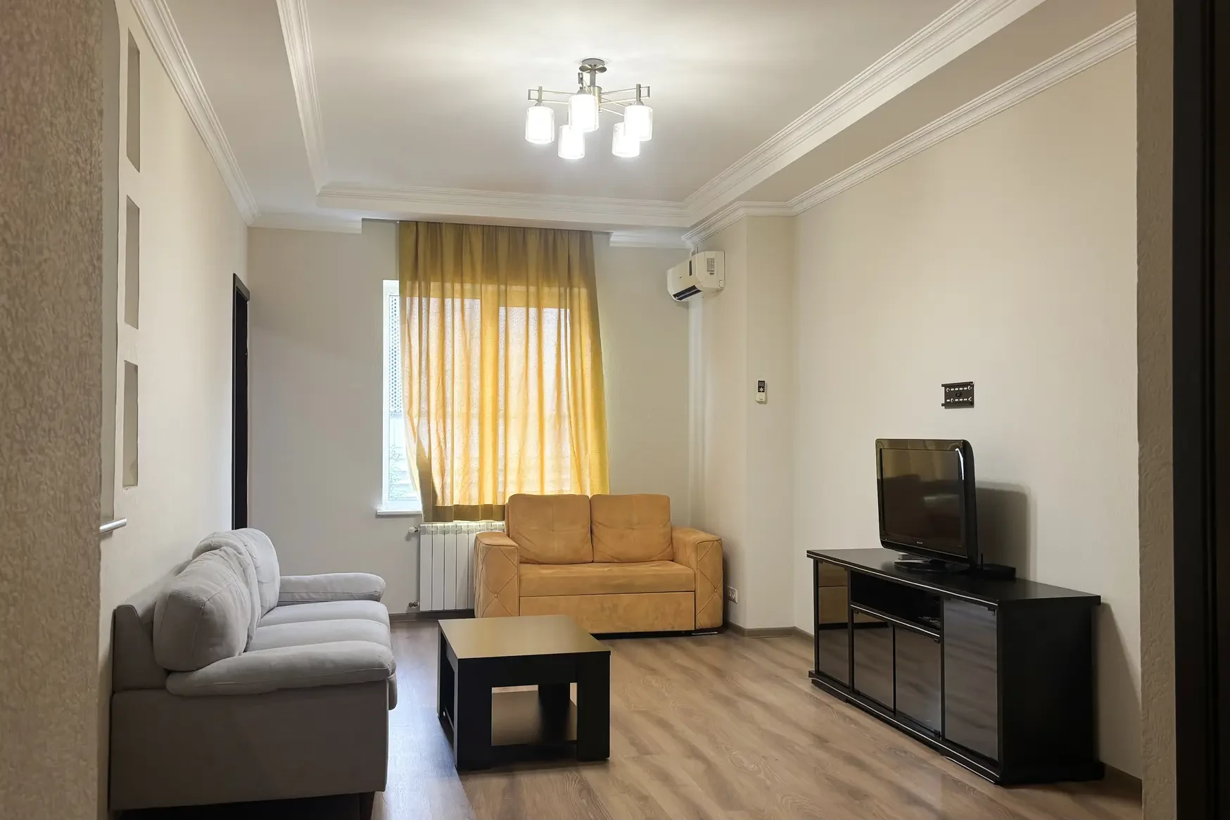 3-room apartment for rent on Chavchavadze Avenue 5, Vake, Tbilisi — living room with sofas, TV and air conditioning