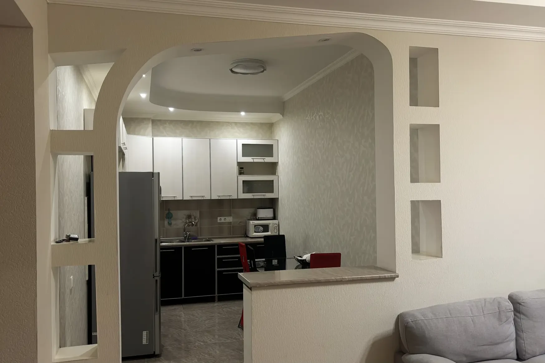 3-room apartment for rent on Chavchavadze Avenue 5, Vake, Tbilisi — open-plan kitchen seen through the arch from the living room