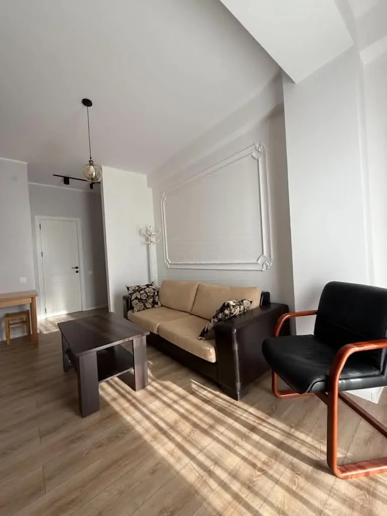 3-room apartment for rent on Chkondideli Street, Nadzaladevi, Tbilisi — living room with sofa and coffee table