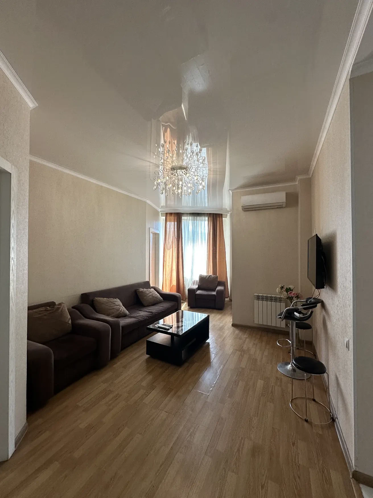 3-room apartment for rent on Shartava Street, Saburtalo, Tbilisi — living room with sofas, coffee table and wall-mounted TV