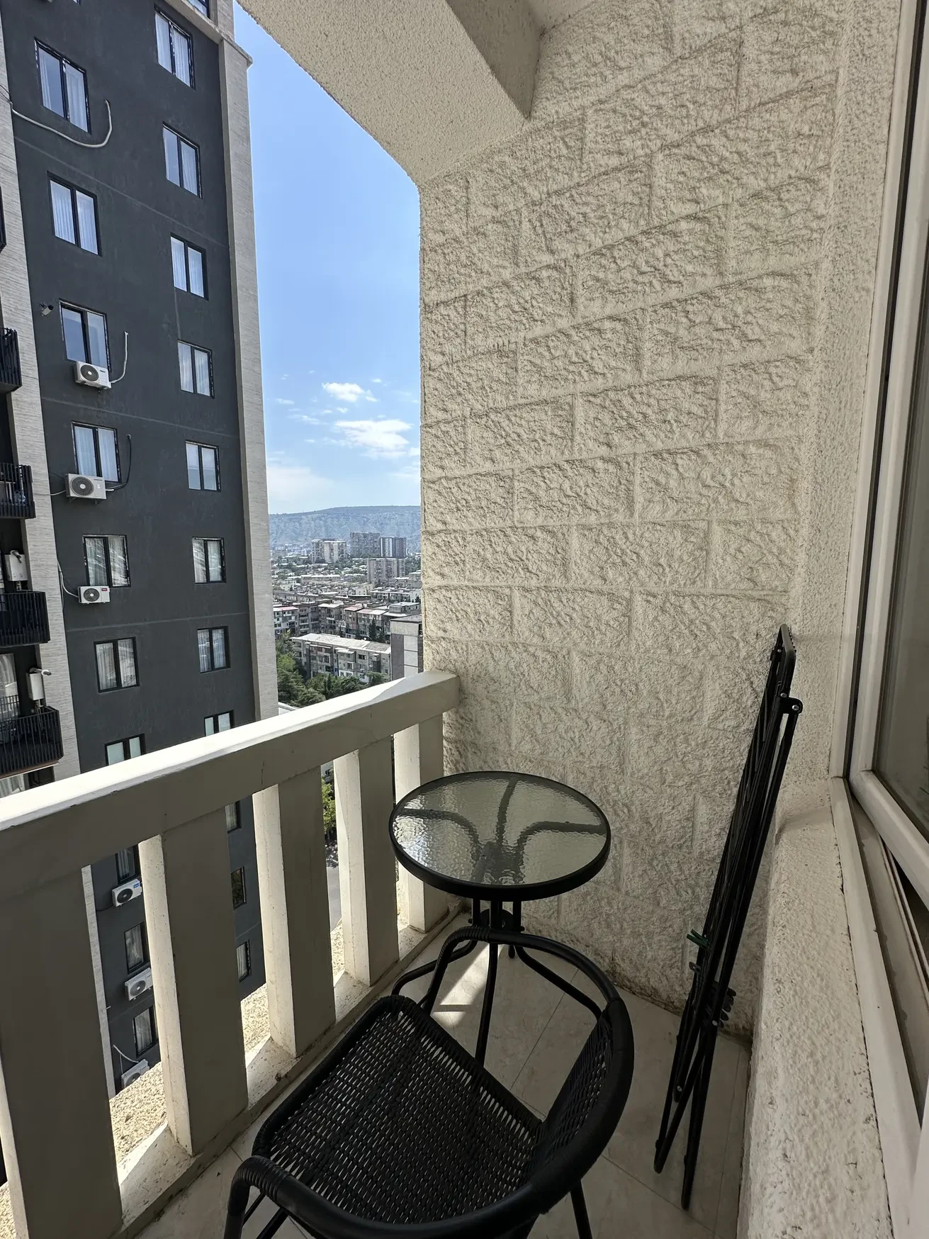 3-room apartment for rent on Shartava Street, Saburtalo, Tbilisi — balcony with table and chairs overlooking the city