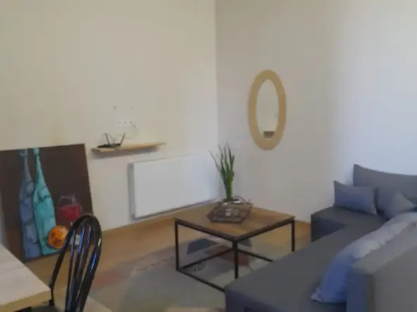 3-room apartment for rent on Tskneti Highway, Bagebi, Tbilisi — living room with sofa, coffee table and dining corner