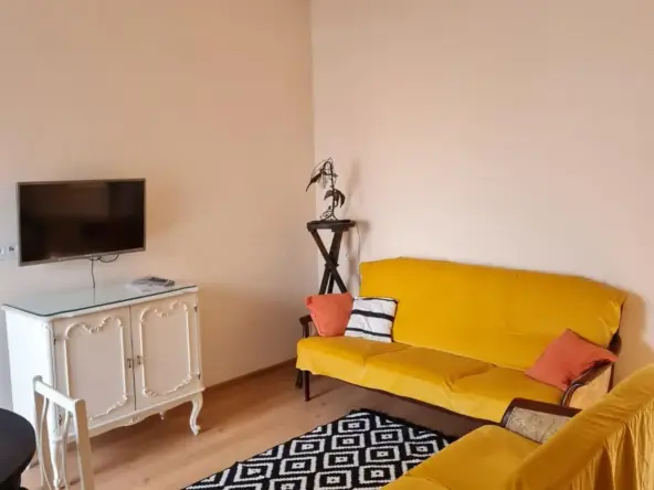 3-room apartment for rent on Tskneti Highway, Bagebi, Tbilisi — living room with TV and two yellow sofas