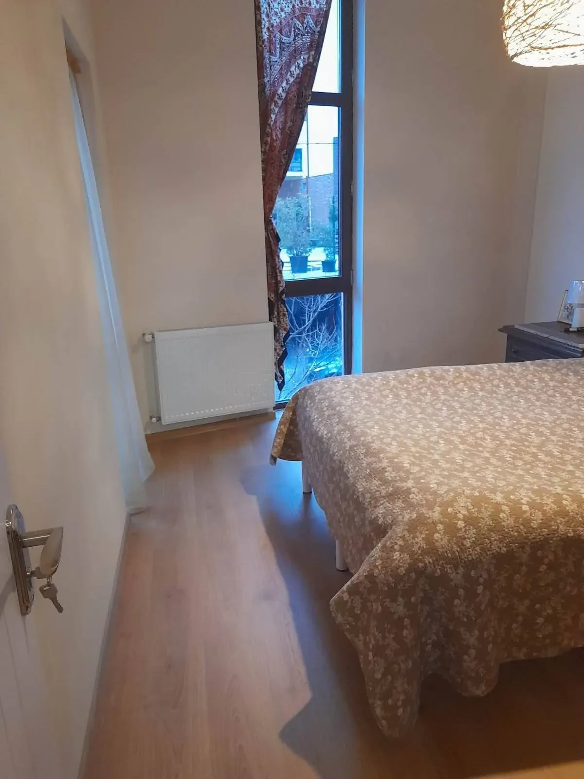 3-room apartment for rent on Tskneti Highway, Bagebi, Tbilisi — bedroom with double bed and floor-to-ceiling window