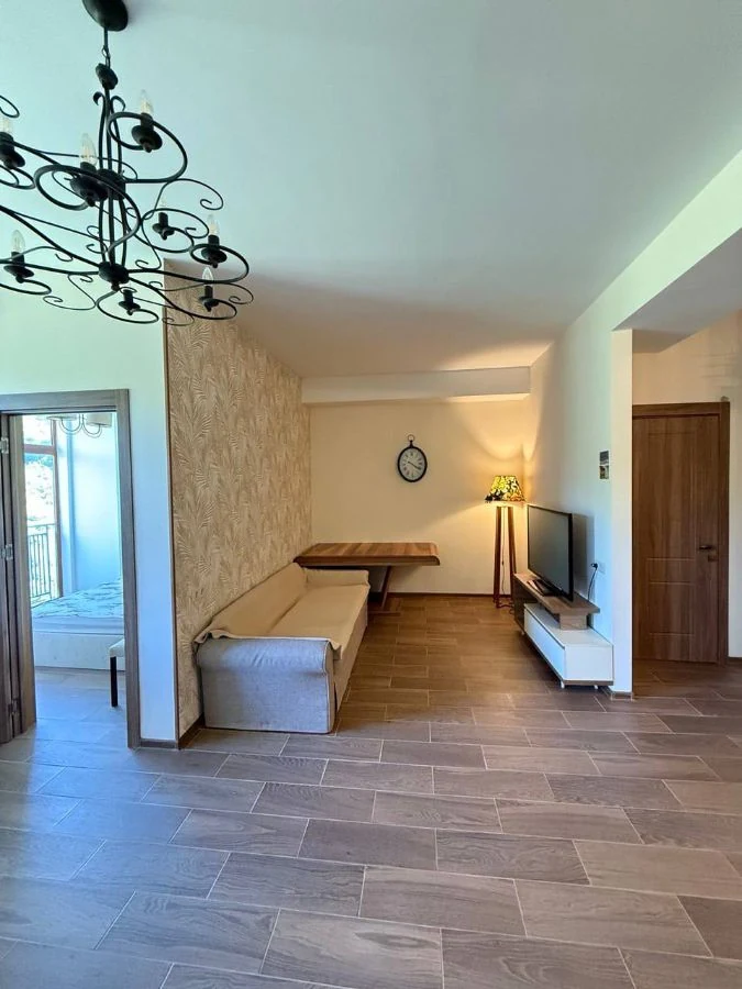 3-room apartment for sale on Chavchavadze Avenue, Vake, Tbilisi — open-plan living room with dining table and seating area