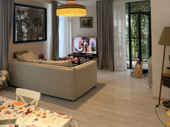 3-room apartment for sale on Marabda Street, Vake, Tbilisi — living room with sofa, TV and balcony doors