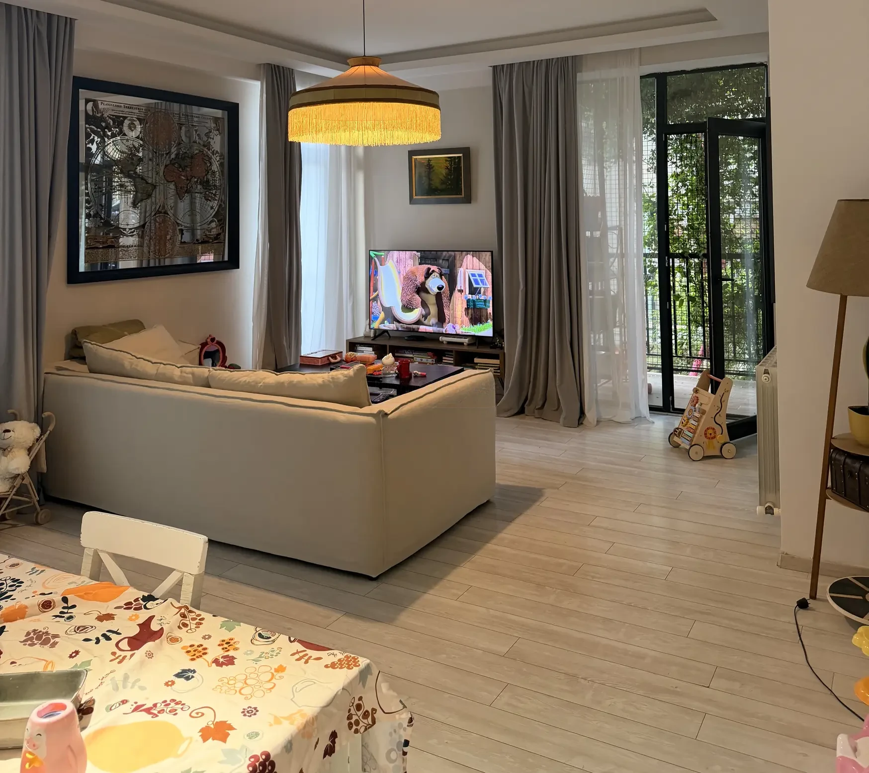 3-room apartment for sale on Marabda Street, Vake, Tbilisi — living room with sofa, TV and balcony doors