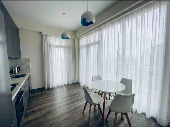 3-room apartment for sale on Marabda Street, Vake, Tbilisi — fitted kitchen and dining area with floor-to-ceiling windows