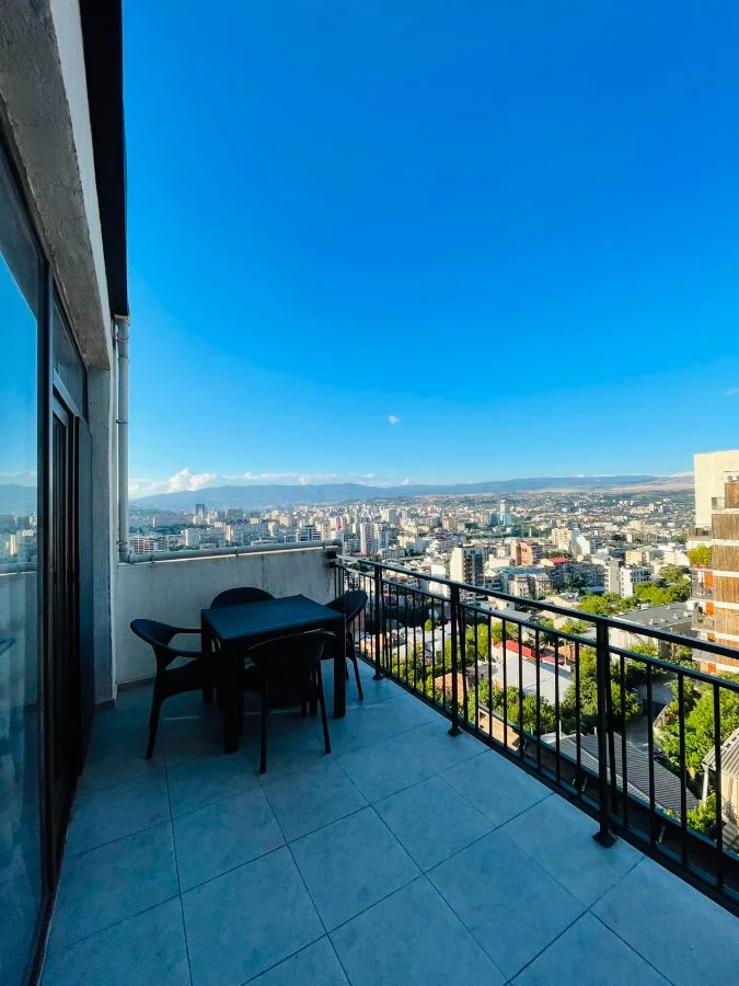 3-room apartment for sale on Marabda Street, Vake, Tbilisi — covered balcony with outdoor table and city panorama