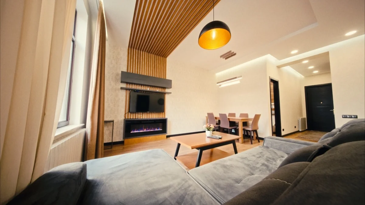 3-room apartment for sale on Mtskheta Street, Vake, Tbilisi — living room with electric fireplace and oak slat wall