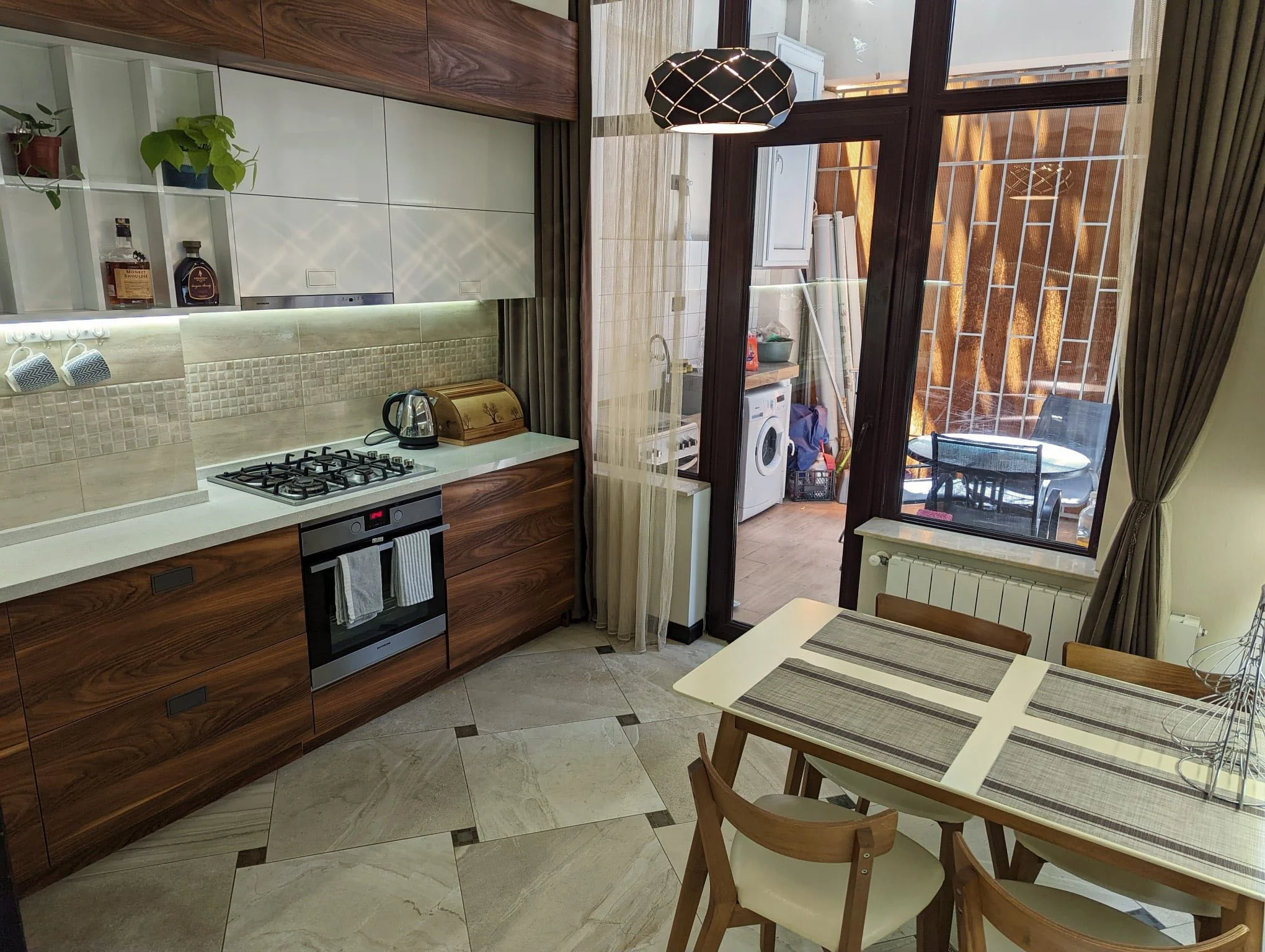 3-room apartment for sale on Mtskheta Street, Vake, Tbilisi — separate kitchen with dining table and balcony door