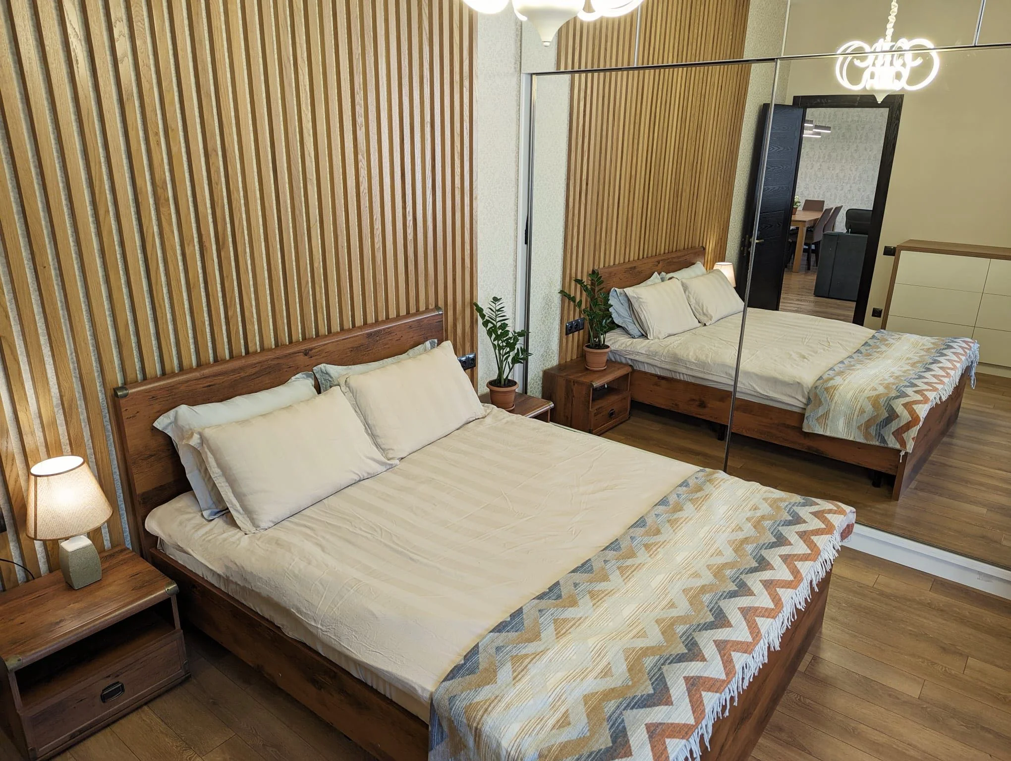 3-room apartment for sale on Mtskheta Street, Vake, Tbilisi — master bedroom with oak slat feature wall