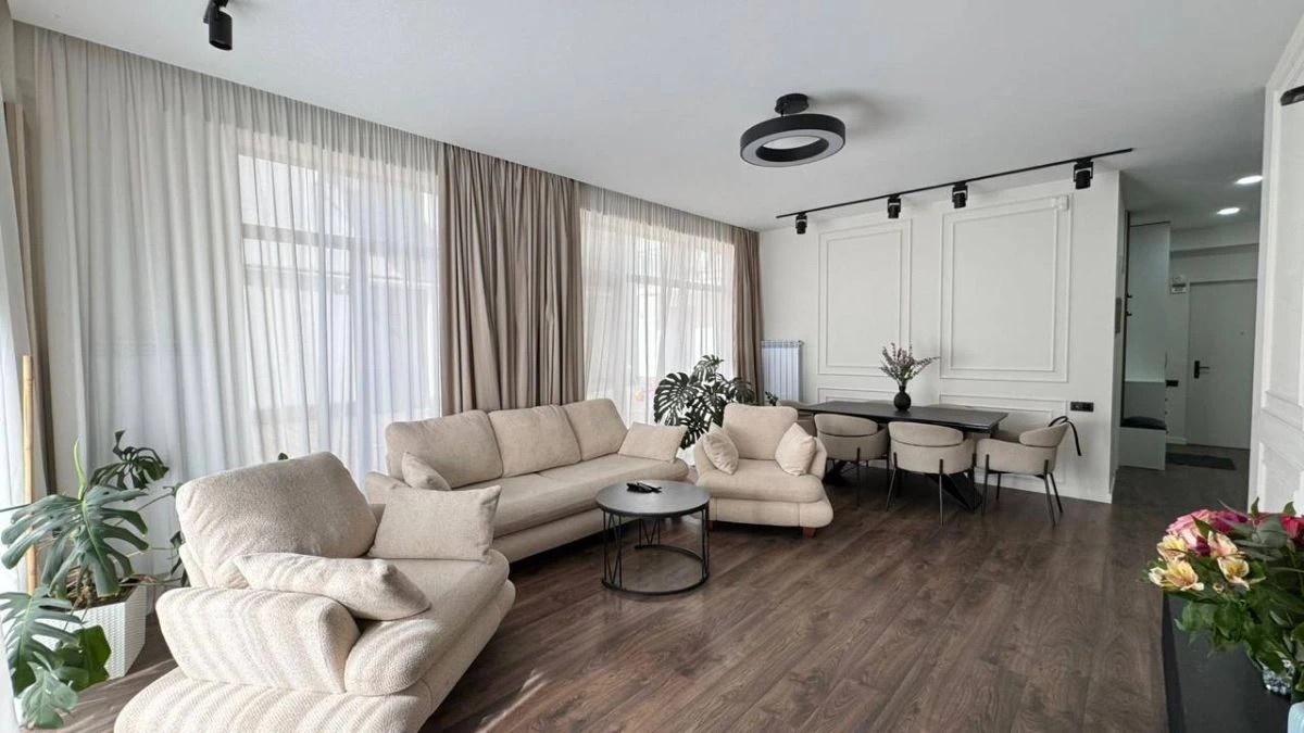 3-room apartment for sale on Nino Zhvania Street, Vake, Tbilisi — living room with dining area beyond