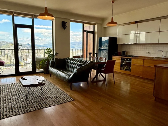 4-room apartment for sale on Marabda Street, Vake, Tbilisi — living room, dining area and open kitchen with panoramic windows