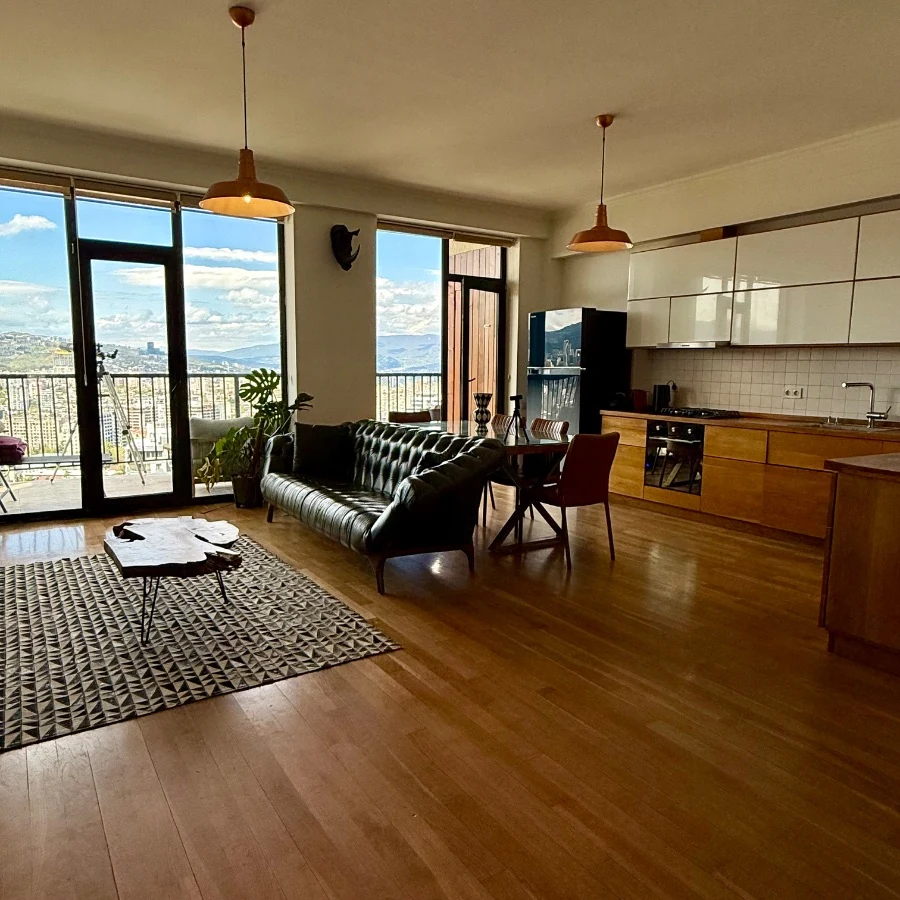 4-room apartment for sale on Marabda Street, Vake, Tbilisi — living room, dining area and open kitchen with panoramic windows