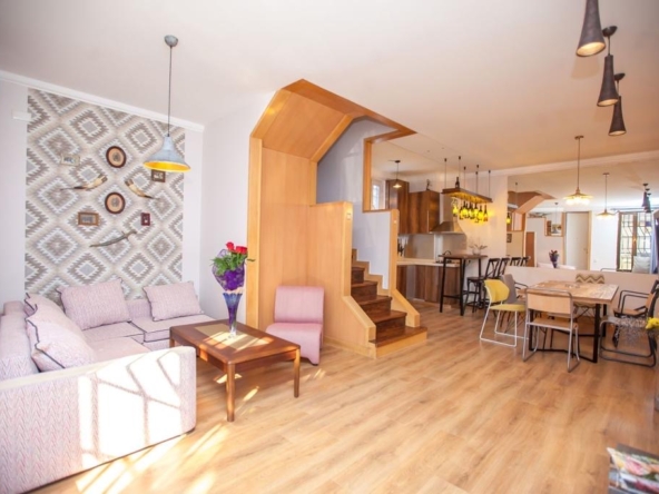 7-room house for sale on Marjanishvili Street, Chughureti, Tbilisi — open-plan living and dining room with staircase
